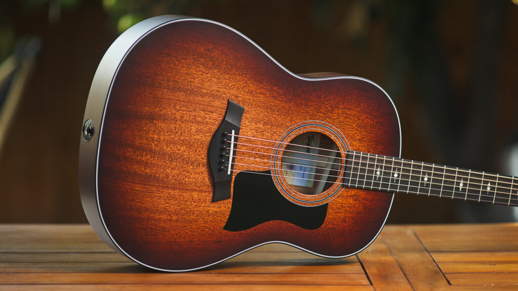 The body of an acoustic guitar. It is round with a shape like the number 8 and has a large hole in the middle.