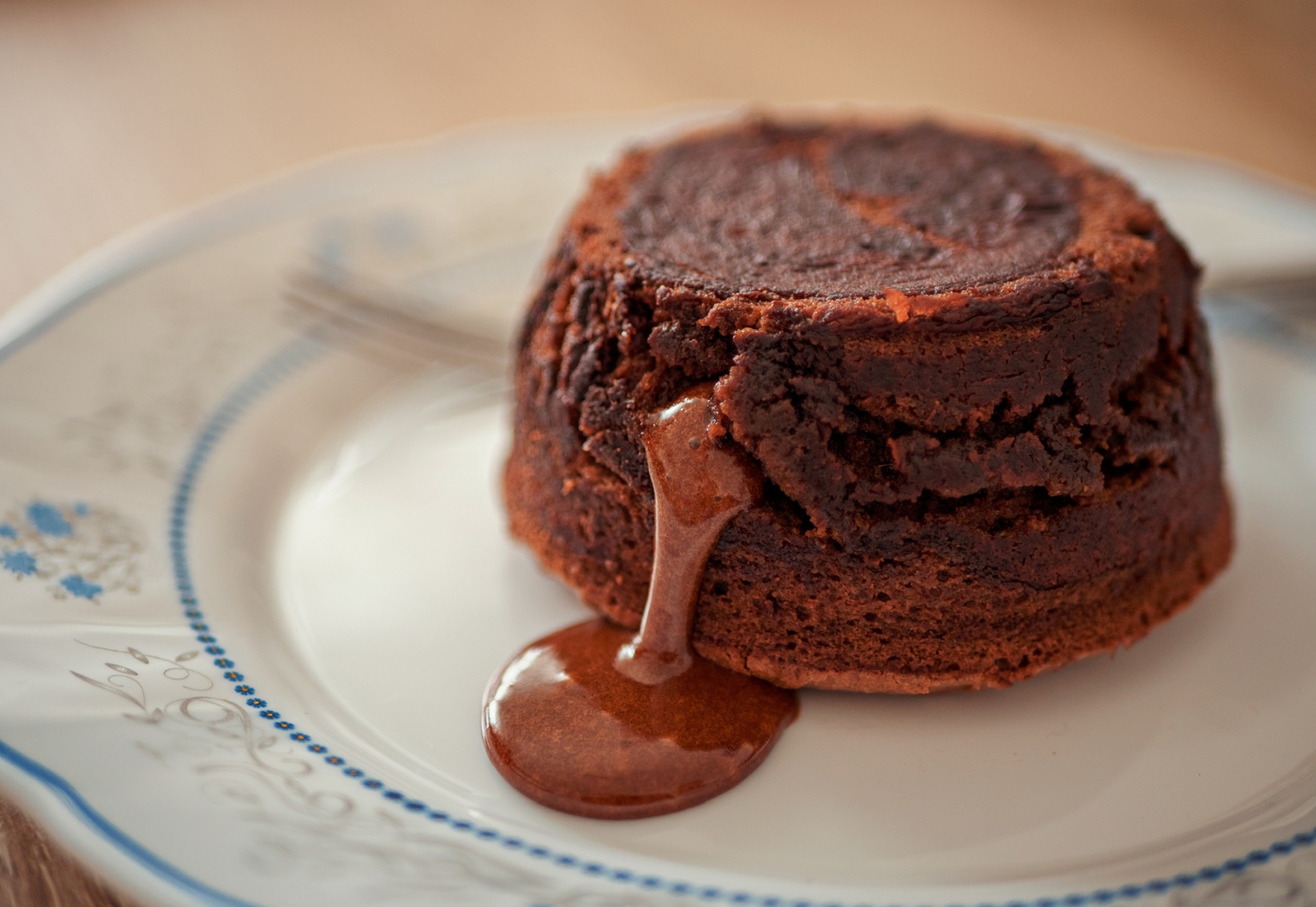 Molten chocolate lava cake with chocolate oozing out of it.